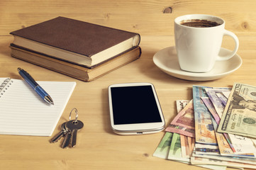 Still life photo of smartphone, notebook, coffee, book, pencil,