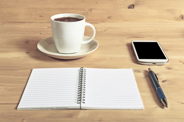 Still life photo of smartphone, notebook, coffee and pencil on w