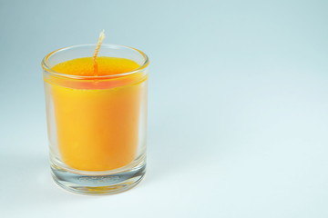 orange candles aroma in clear glass on white background
