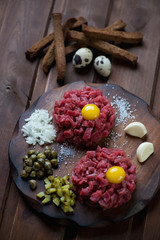 Beef tartare with egg yolk, capers, pickles, onion and garlic