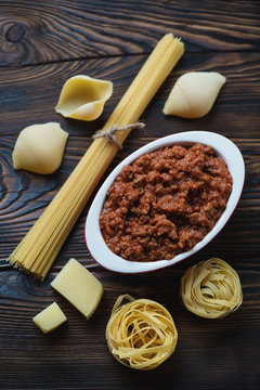 Bolognese sauce and various types of italian pasta, close-up