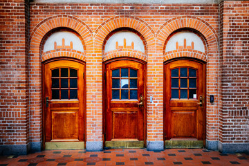 Old vintage wooden doors and brick wall at train station in Copenhagen, Denmark
