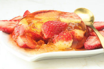 gelatin dessert and fresh strawberries on white marble