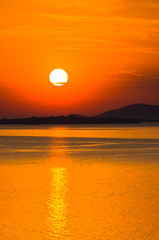 Sunset at sea, with small greek islands in background