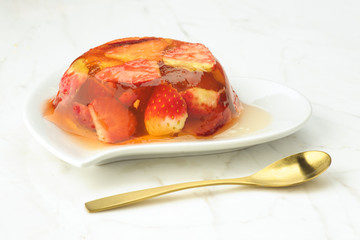 gelatin dessert and fresh strawberries on white marble