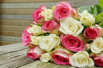 pink and white  roses on the wooden table.
pink and white flower for a special day
