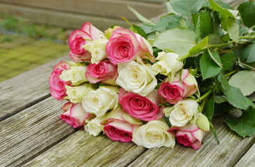 pink and white  roses on the wooden table.
pink and white flower for a special day