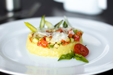 risotto with cheese and vegetables on white plate