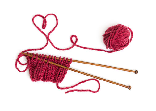 Knitting pattern on wooden needles of woolen threads