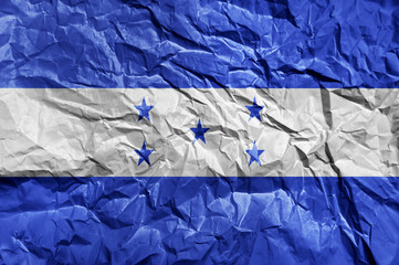 Honduras flag painted on crumpled paper background