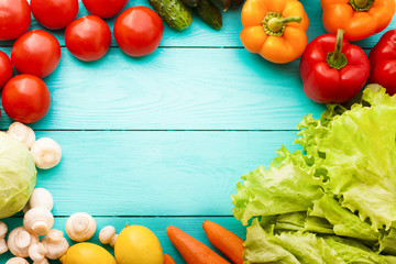 Frame of vegetables with copy space on blue wooden background. Top view