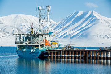 LONGYEARBYEN, SPITSBERGEN, NORWAY - 08 APRIL, 2015: Loading cargo on a cargo ship in port on Svalbard