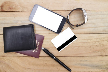 Travel arrangement of wallet with credit card , passports, compass on wood table background. Travel concept.