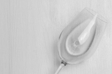 wine glass with water isolated on white wood textured background