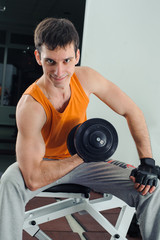 Fototapeta na wymiar Man makes exercises for biceps