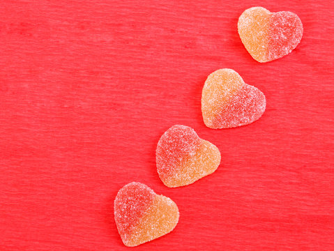 jelly hearts four pieces on a red paper background