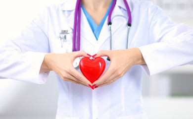 Doctor with stethoscope examining red heart