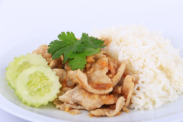 Thai Favorite Dish, Fried sliced pork with garlic with rice and cucumber in Bangkok, Thailand