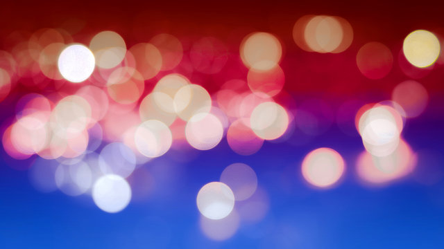 Abstract blur bokeh background with the colors of the American flag, real defocused lights.