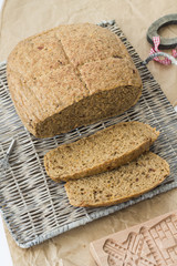 Wheat bread. Buckweat bread with dried tomatoes and thyme, on white background, basket and grey paper. 
