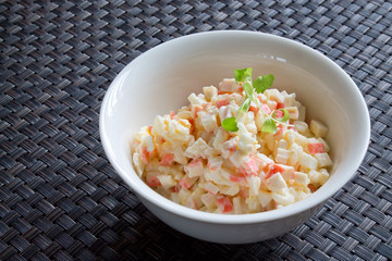 Crab salad with mayonnaise on table