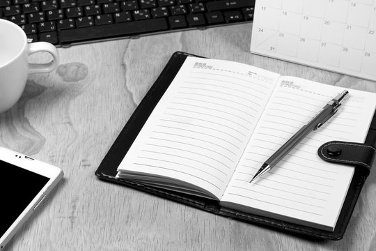 notebook on office desk,black and white, selective focused