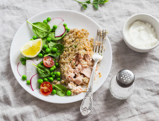 Baked salmon with lemon bread crust and fresh vegetable salad with peas, spinach, radishes and cherry tomatoes. Delicious healthy dinner