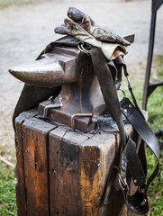 Worn iron anvil apron and gloves