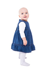 side view of cute baby girl standing isolated on white