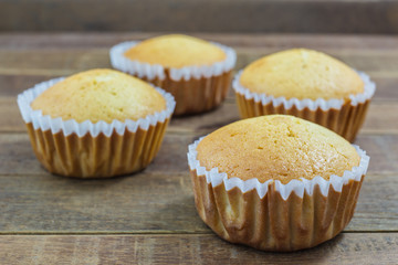 Homemade Vanilla cupcake on wooden background