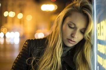 sexy blonde melancholy at night in a city