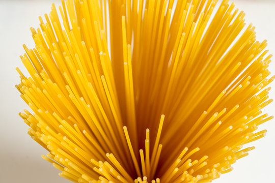 Top view of uncooked spaghetti pasta in glass.