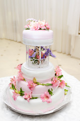 Wedding Cake decorated with pink lily flowers