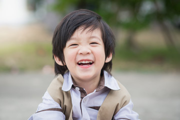 Close up portrait of boy laughing..