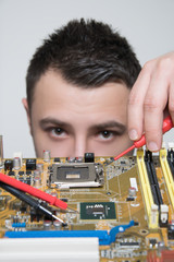 Young computer engineer fixing computer