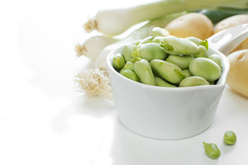 Fava beans with onion,potato on white
