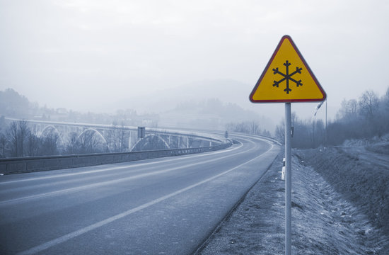 Snowy Road With Frozen Sign In Winter, Cold Concept