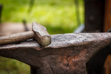 Worn iron anvil and hammer