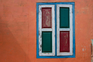 Fototapeta na wymiar Wall. Orange wall. Window. Colored shutters. Walls and paints. Backgrounds. Textures.