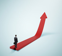 businessman standing on red arrow