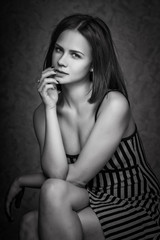 Fototapeta premium Portrait of wonderful young woman with long hair looking at camera, smiling