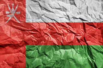 Oman flag painted on crumpled paper background