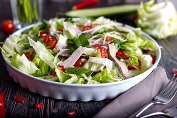 Asian beef salad with cucumber, lettuce and chilli