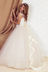 Fototapeta premium gorgeous young bride with blond curly hair, wears elegant wedding dress and crown