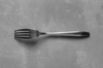 Fork on the concrete background