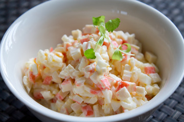 Crab salad with mayonnaise on table