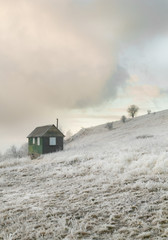Fototapeta na wymiar Winter house on a hill, winter landscape