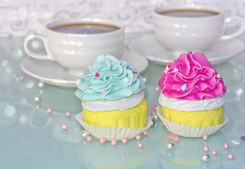 pink and blue muffins and cup of coffee