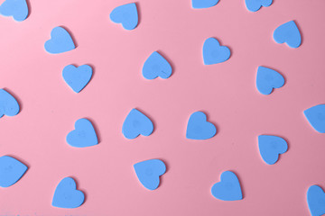 multiple blue heart shapes as pink background Valentine's Day.