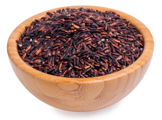 Black rice in a wooden bowl on a white background